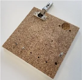 Bio-based fibreboard with hinge and drilled holes